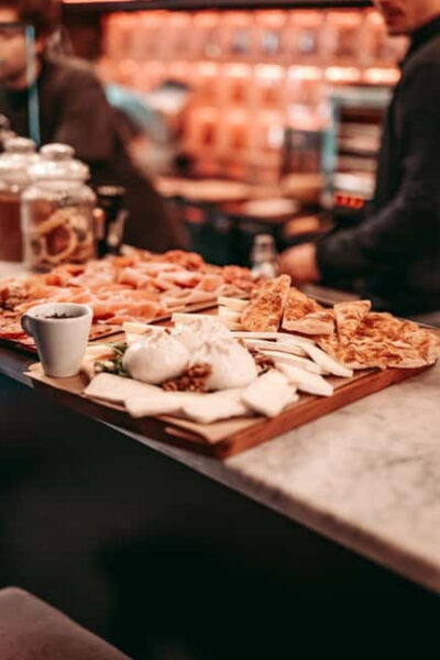 Barcelona: Tipsy Tapas & History Tour in the Gothic Quarter - Plaza Real: the opening bar stop and drink-pairing vibe