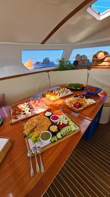 From Palma: Luxury Catamaran Group Tour with Tapas & Drinks - The anchor-and-swim bay in turquoise water