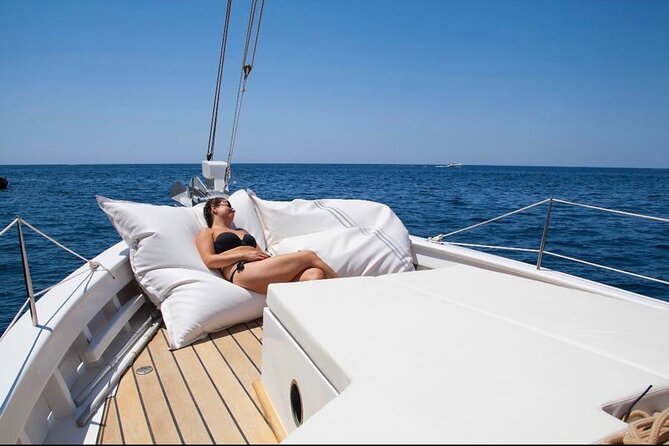 Ibiza: Private Sailboat with Tapas, Open Bar & Music - Entering the Water: Cala Bassa and the Snorkel Hour