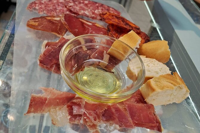 Madrid Food Tour: Tapas, Drinks and Delights with a Local - Cold cuts near the Antonio Mingote mural: Cebo, Lomo, Chorizo, Salsichón