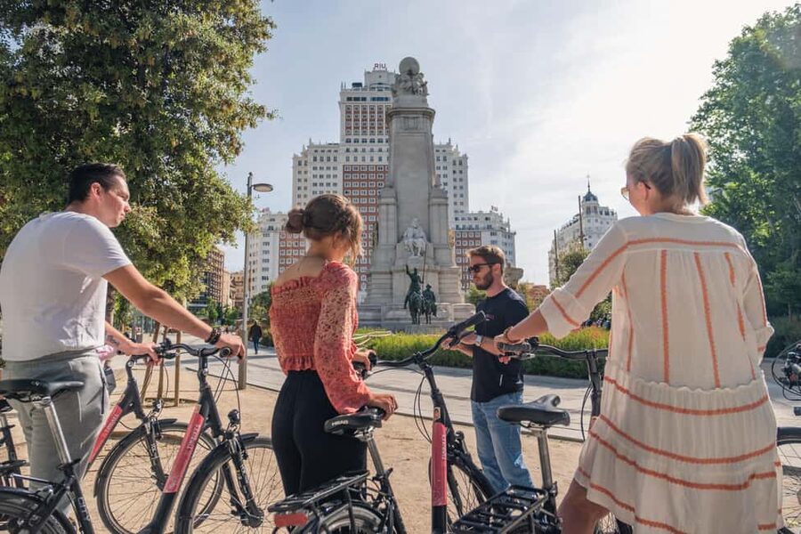 Madrid: Highlights Bike Tour with Optional E-Bike or Tapas - Plaza de Oriente: Filip IV stories and Royal Palace-area views