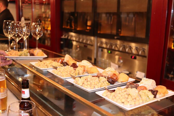 Madrid Small Group Tapas Tour at 4 Venues -Lunch or Dinner - What you’ll actually taste: wine, ham, and classic tapas variety