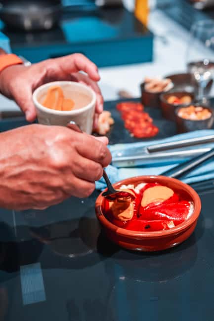 Madrid: Tapas Cooking Class with bottomless Wine Pairing - Welcome cava and the 120-year-old cellar dining room