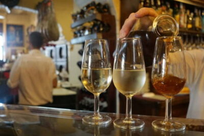 Seville: Tapas Walking Tour with Traditional Flamenco Show - The warm-up bar: cured meats, beer or wine, and sweet vermouth