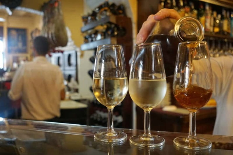 Seville: Tapas Walking Tour with Traditional Flamenco Show - The warm-up bar: cured meats, beer or wine, and sweet vermouth